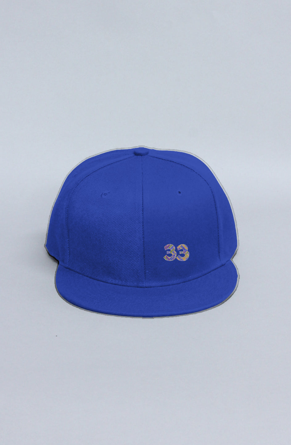  A gray background showcasing a blue cap been displayed