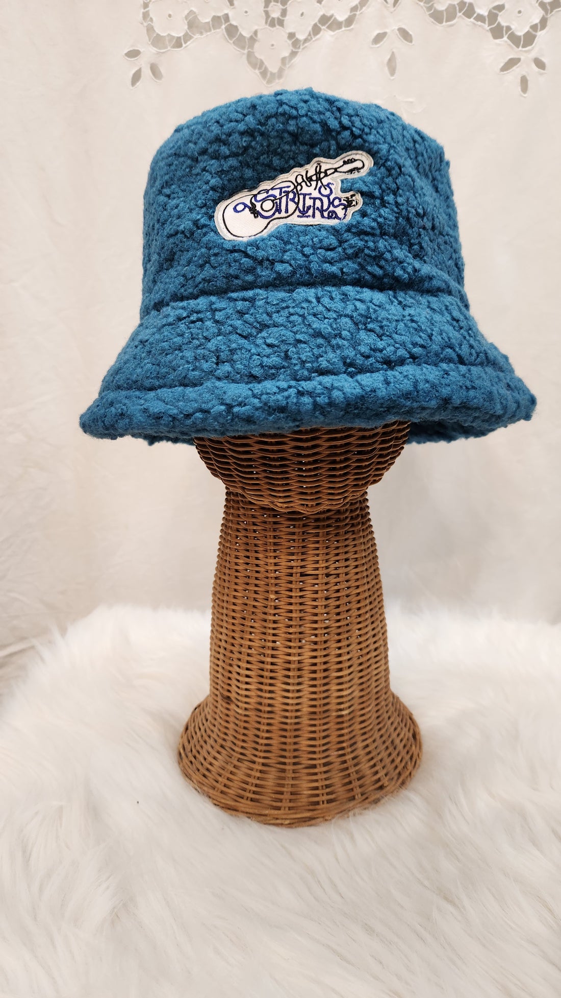 A blue Cashmere Bucket Hat hanged for display